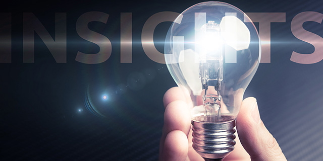 A hand holding a light bulb with text in the background "Insights"