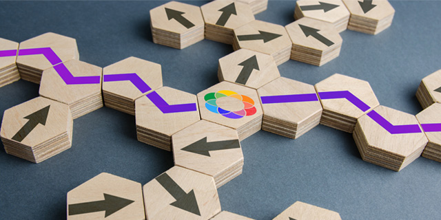 Wooden blocks aligning together with arrows and logo of Max Inclusion in the middle